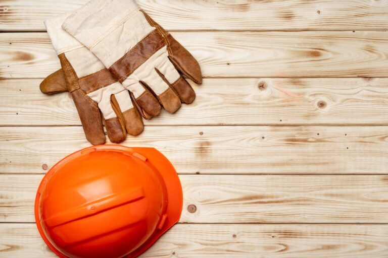 Hardhat and gloves of construction worker top view